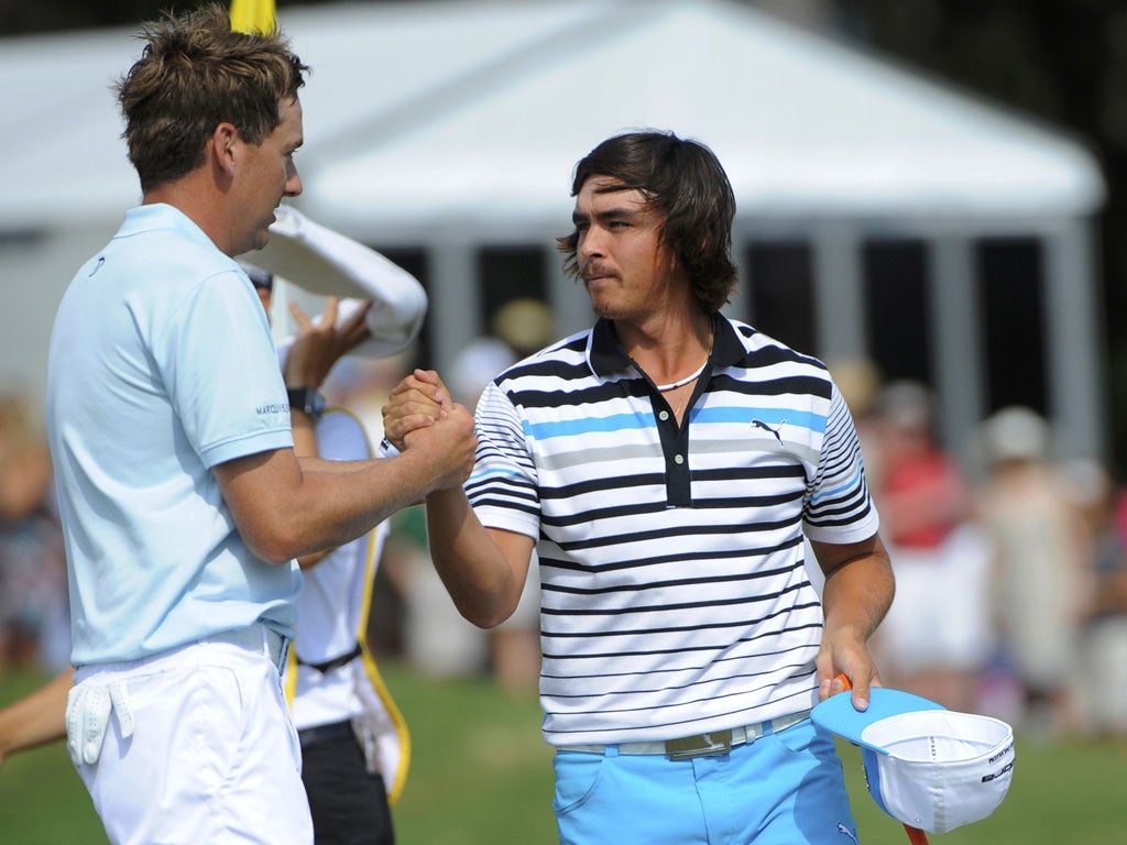 Ian Poulter (left) congratulates Rickie Fowler on his six-under 66 at Sawgrass which leaves him three shots off the lead going into the final round