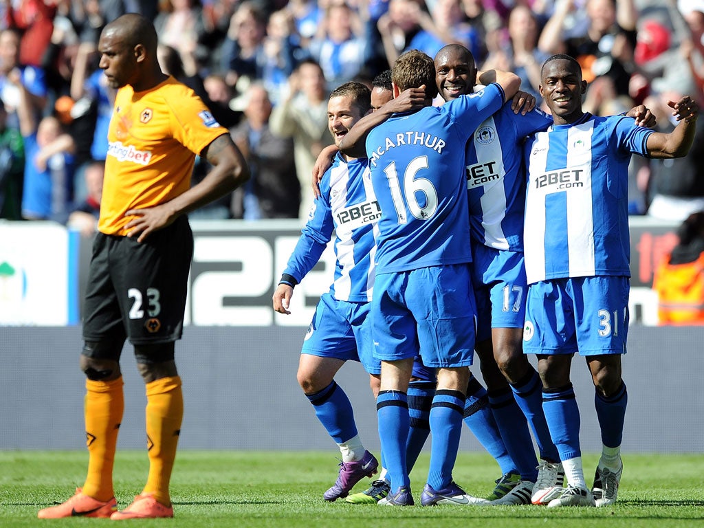 Wigan players celebrate Emmerson Boyce's winner