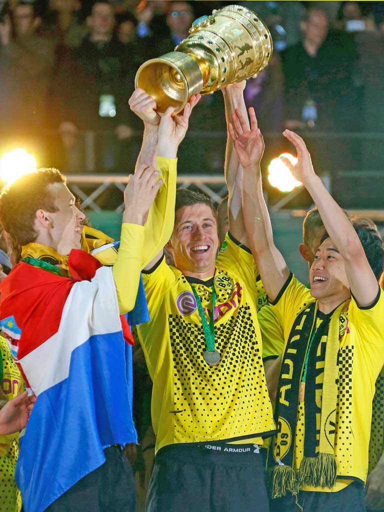 Borussia Dortmund’s hero Robert Lewandowski holds up the trophy