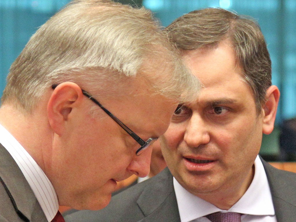 Greek Finance Minister Philippos Sachinidis, right, meets European
monetary commissioner Ollie Rehn as the markets slump