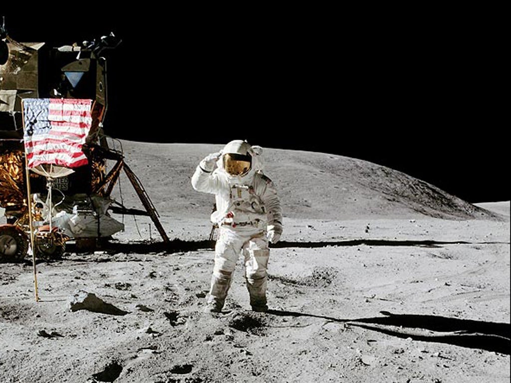 Charlie Duke salutes salutes the United States flag on the moon