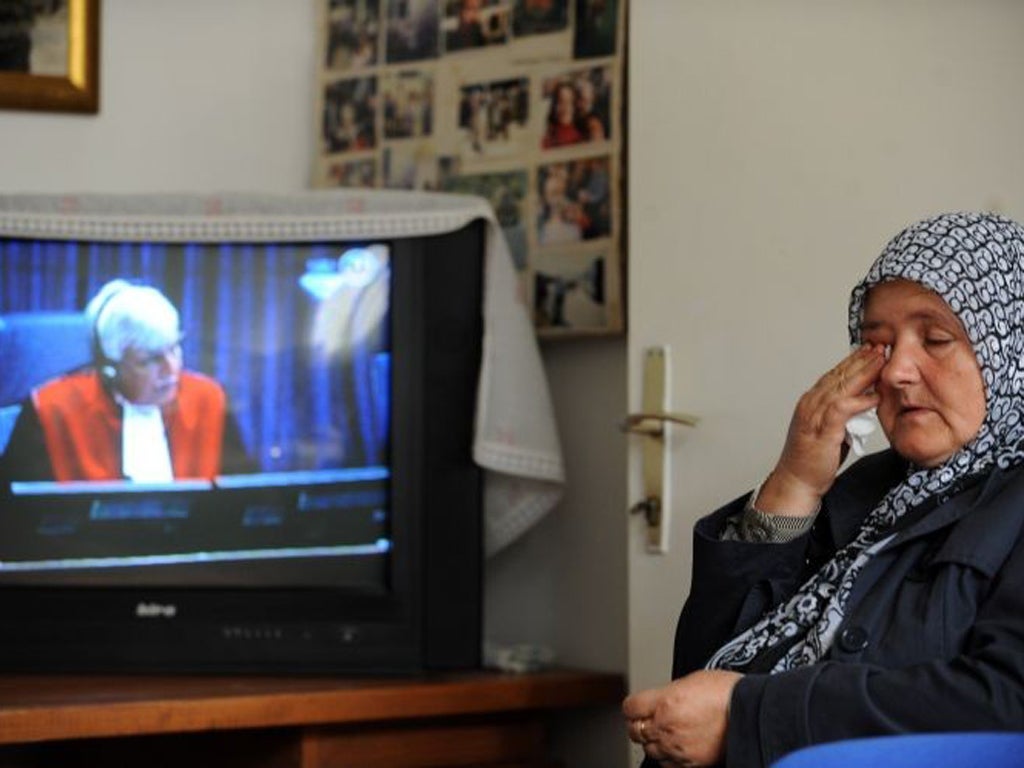 Ramiza Gurdic, 59, who lost her husband and two sons in
Srebrenica, watches the trial in Sarajevo