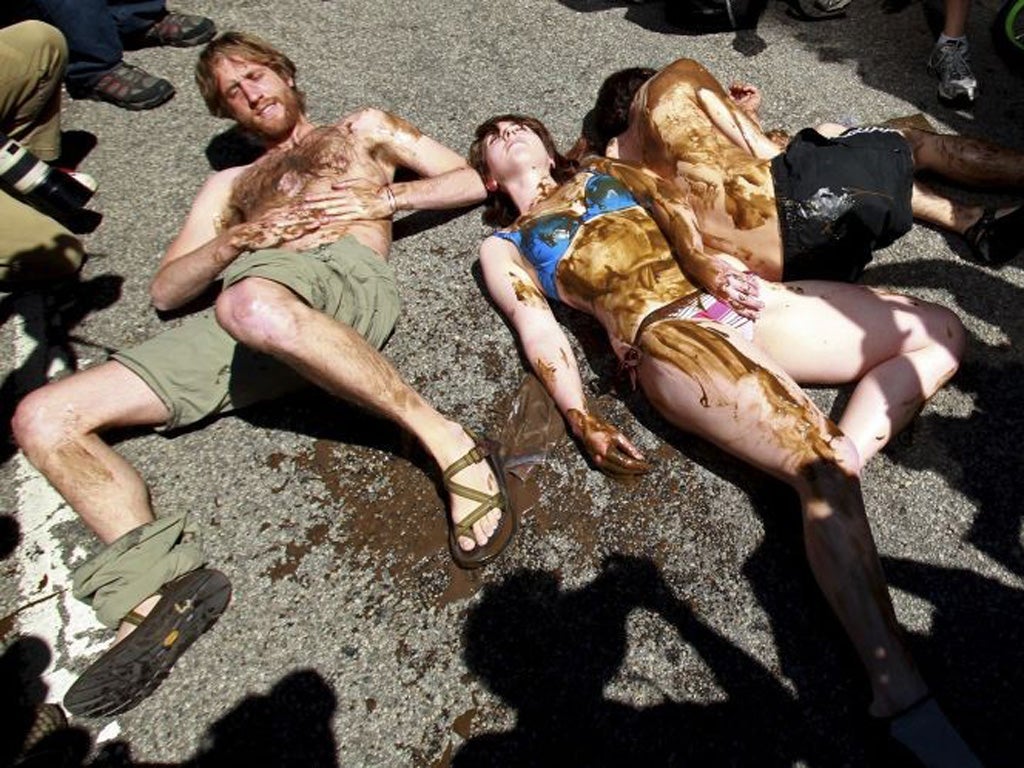 Environmental activists lie in the street during an anti-Nato rally outside the Canadian consulate in Chicago