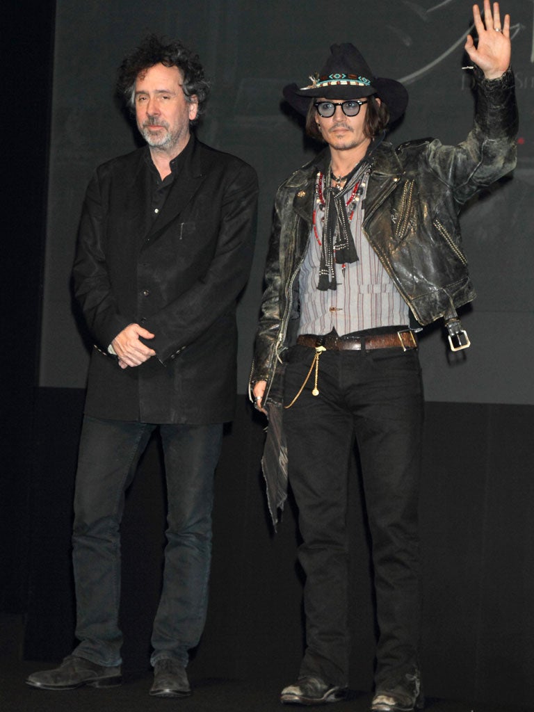 Depp, right, with the more soberly dressed Tim Burton