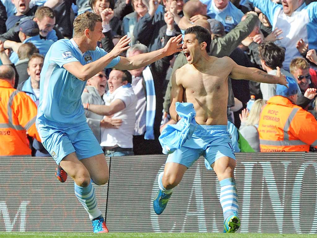 Sergio Aguero (right) celebrates scoring Manchester City’s dramatic winner against Queen’s Park Rangers to win the Premier League title