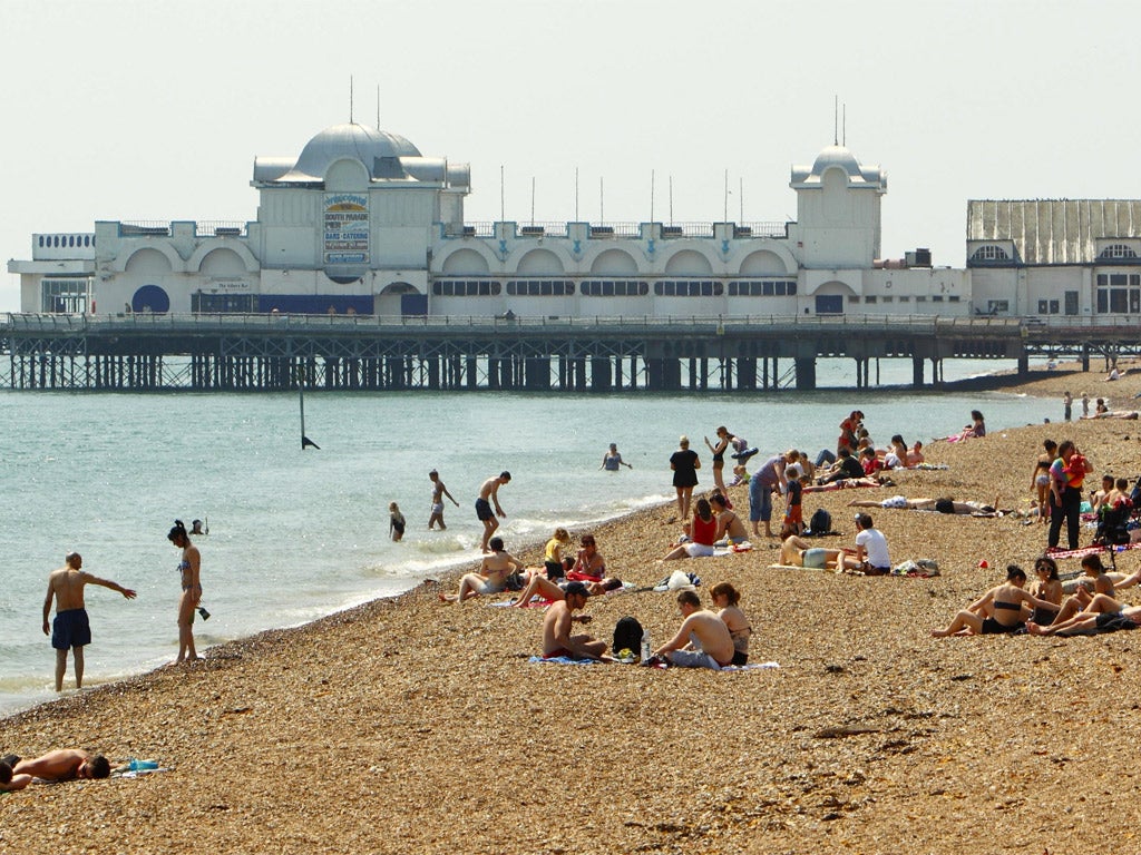 Beach-goers near South Parade Pier in Portsmouth