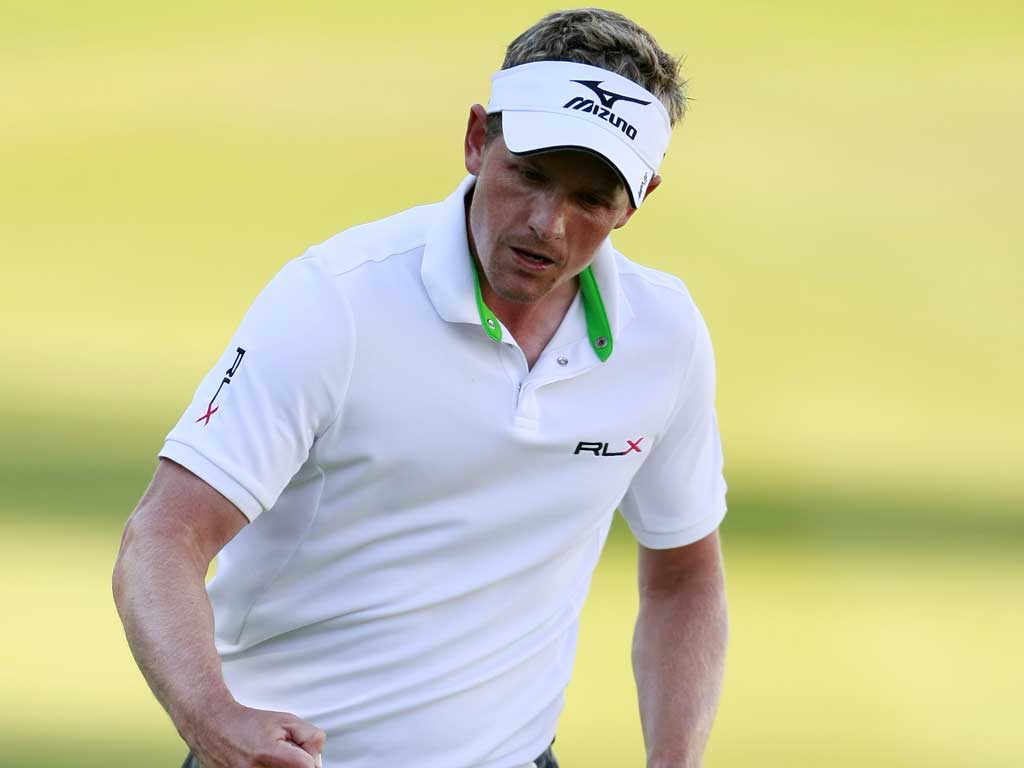 Watch the birdie: Luke Donald celebrates beating par on the 18th green