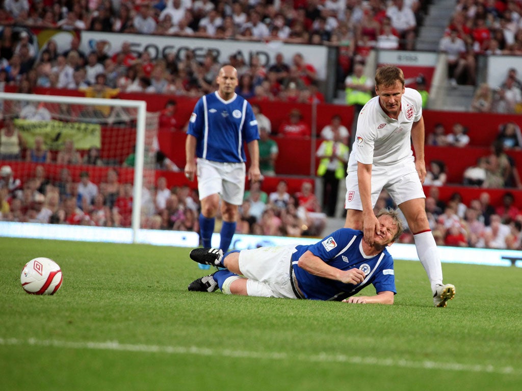 Foul play: Teddy Sheringham clatters Gordon Ramsay