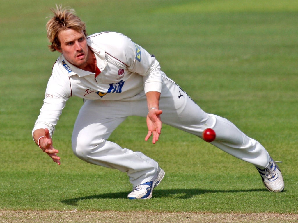 Somerset's Nick Compton stoops to field at New Road yesterday