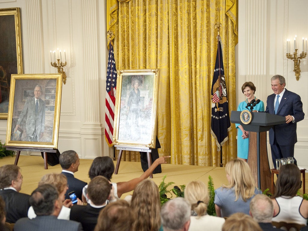 George W Bush and Laura Bush with Barack Obama and Michelle Obama in the front row