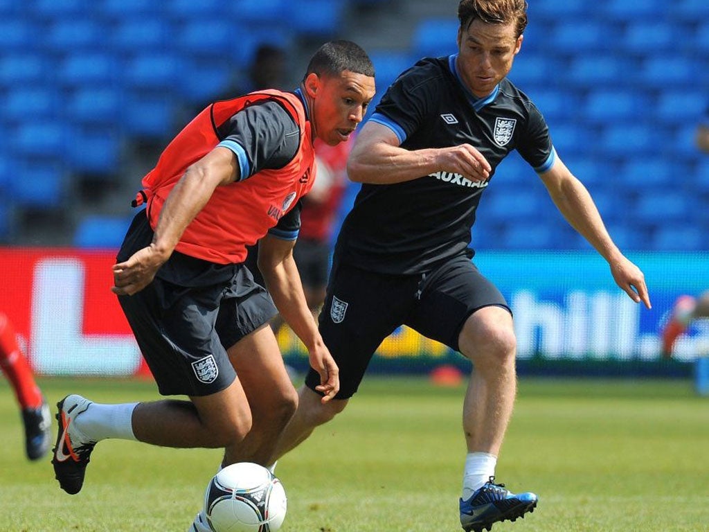 Alex Oxlade-Chamberlain (left) and Scott Parker compete for the ball during England training