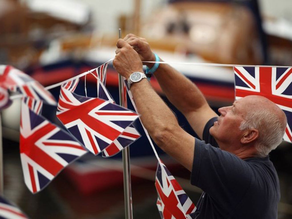 A man put up bunting in preparation for the Jubilee