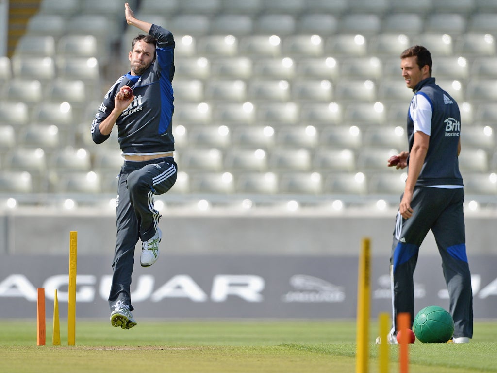 Graham Onions bowls as Steve Finn looks on during practice
