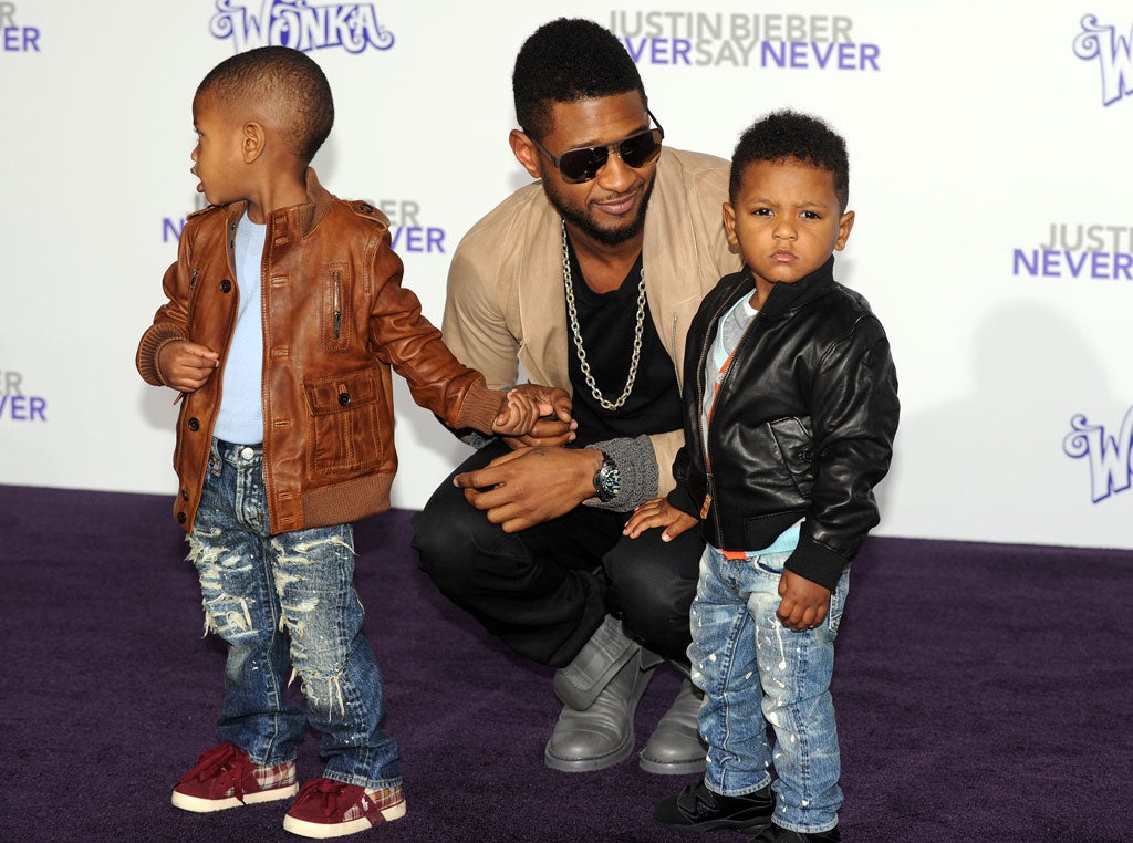 Father figure: Usher arrives with his children at the premiere of Justin Bieber's 3-D concert film 'Never Say Never' in Los Angeles in 2011