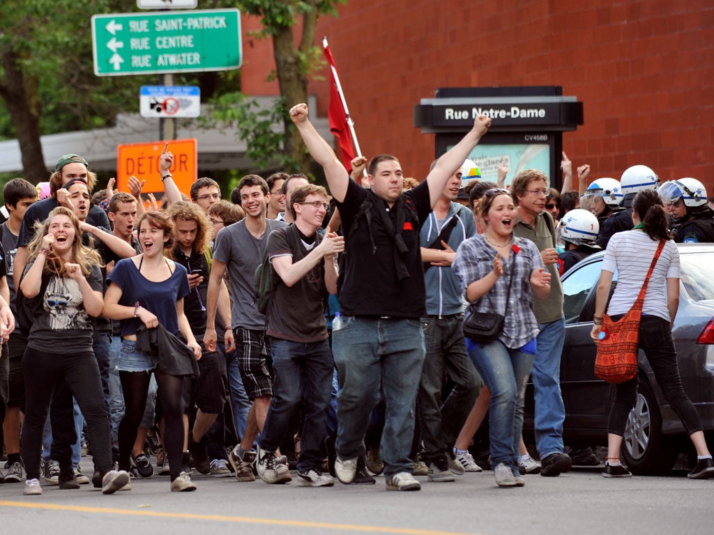 Protestors cheer as police let them leave the site of a student demonstration outside a reception for the Canada Grand Prix