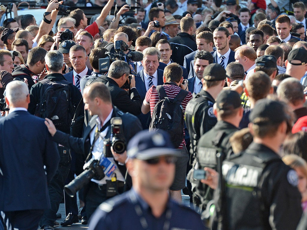 England players pass through crowds in Krakow