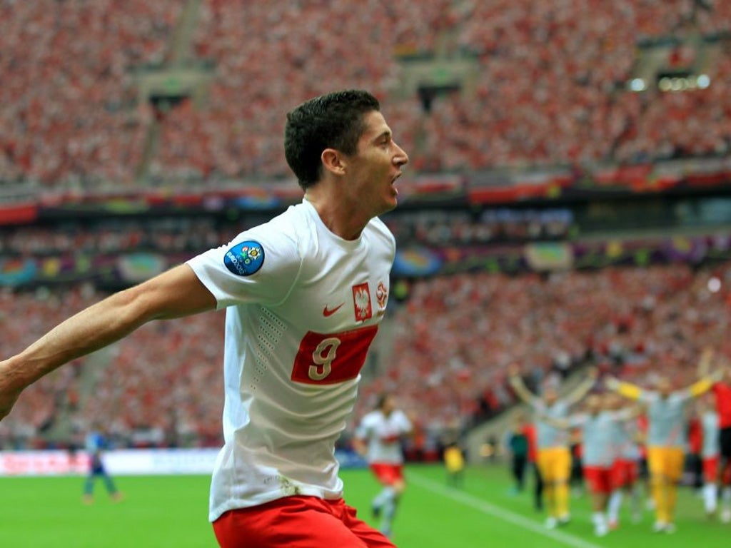 Robert Lewandowski celebrates putting Poland ahead against
Greece yesterday