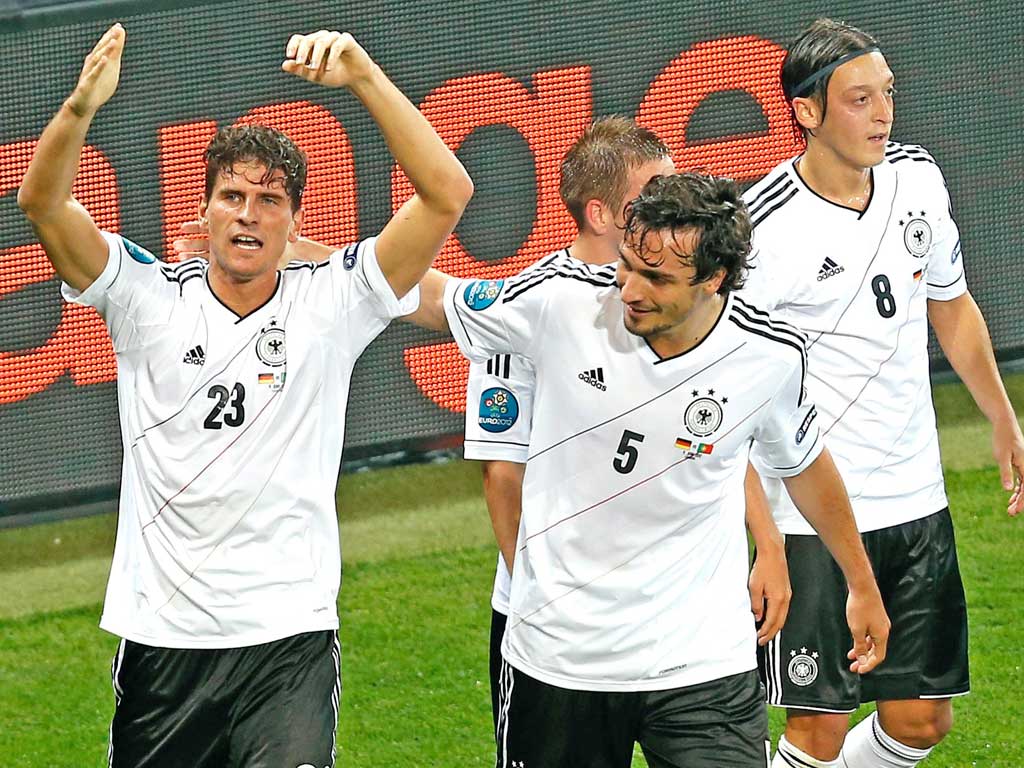 Mario Gomez (left) is congratulated by his German team-mates for scoring the winner against Portugal on Saturday night