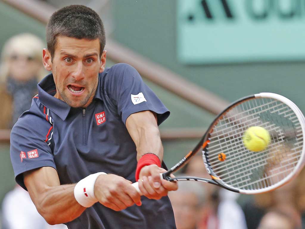 Novak Djokovic plays a backhand as he battles back against Rafael Nadal at Roland Garros