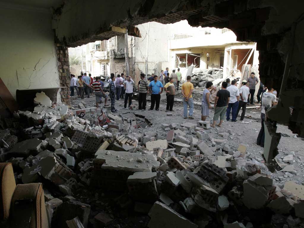 Residents gather at the site of a bomb attack in Kirkuk