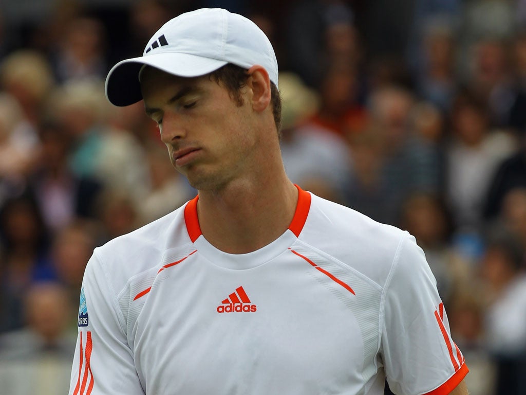 Andy Murray reacts during his first round defeat at Queen's