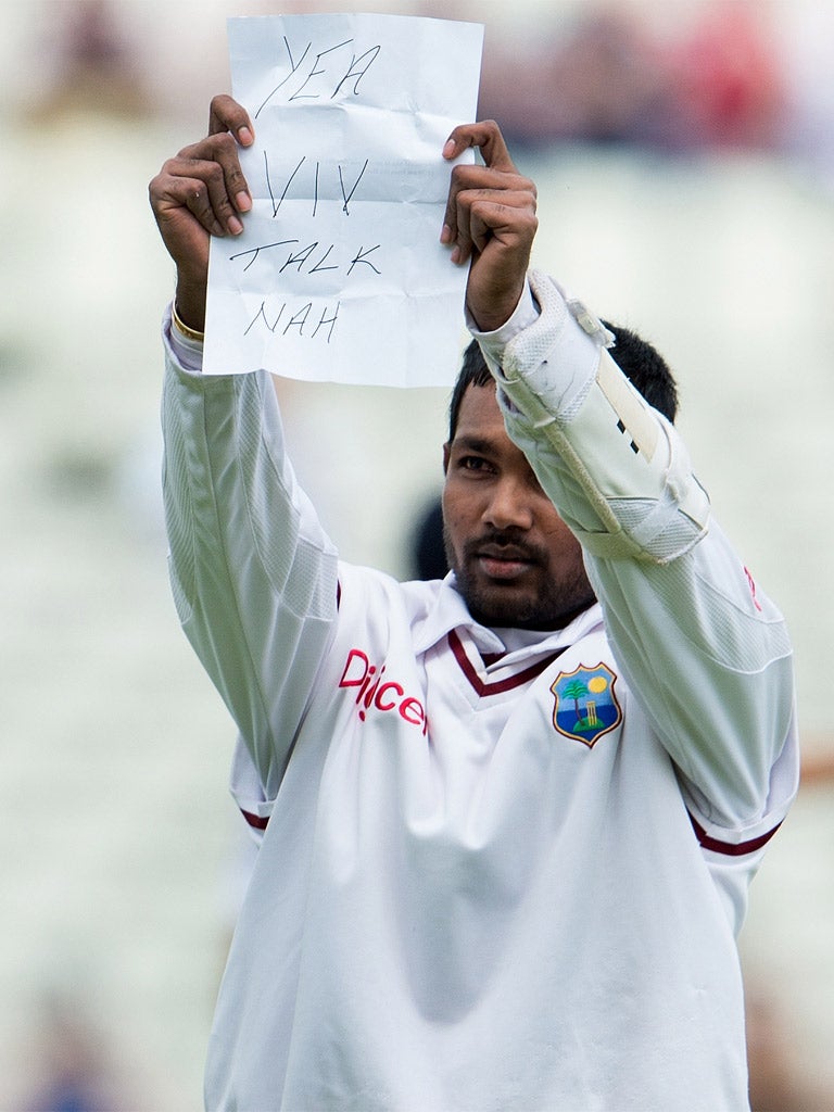 Denesh Ramdin holds up the offending message