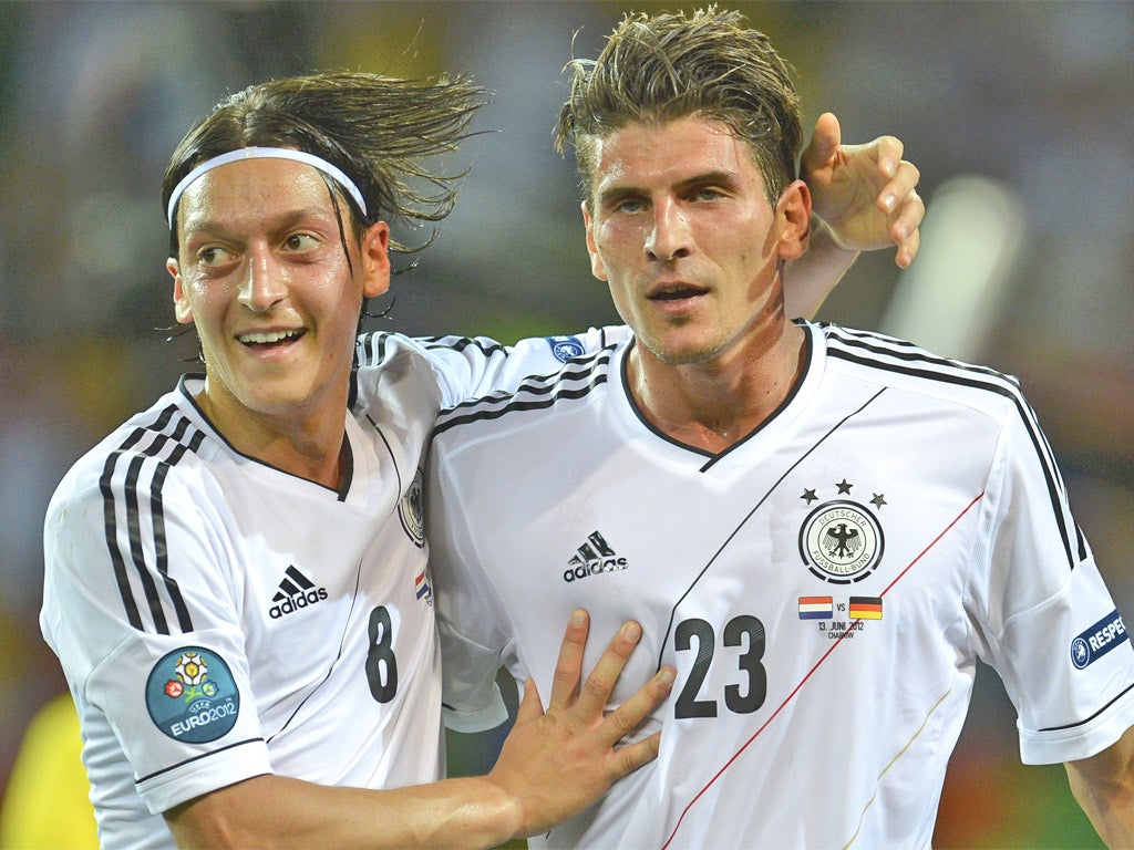 Mario Gomez (right) is congratulated by Mesut Ozil after scoring his and Germany’s second last night