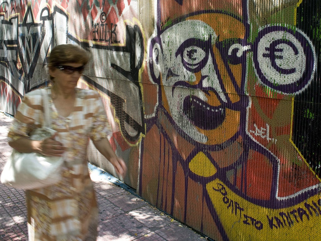 Graffiti about the euro covers an Athens wall