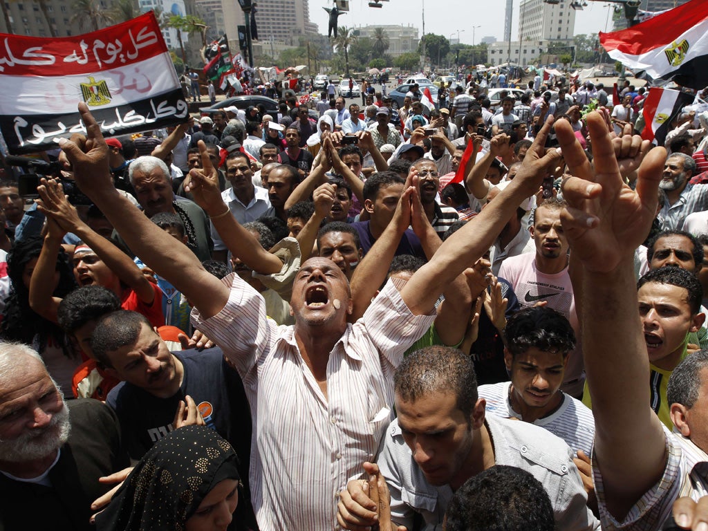 Protesters in Cairo's Tahrir Square shout slogans against the Egyptian military council after Friday prayers yesterday