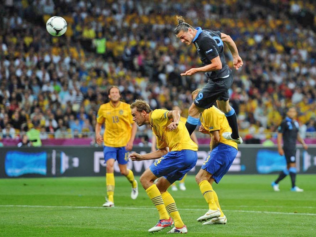 Andy Carroll rises high above the Swedish defence to head England in front in Kiev