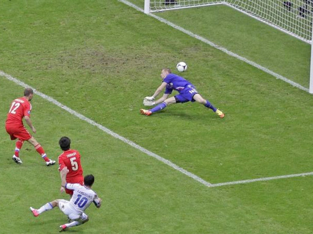 Greece's Giorgos Karagounis shoots past Russia's goalkeeper Vyacheslav Malafeev