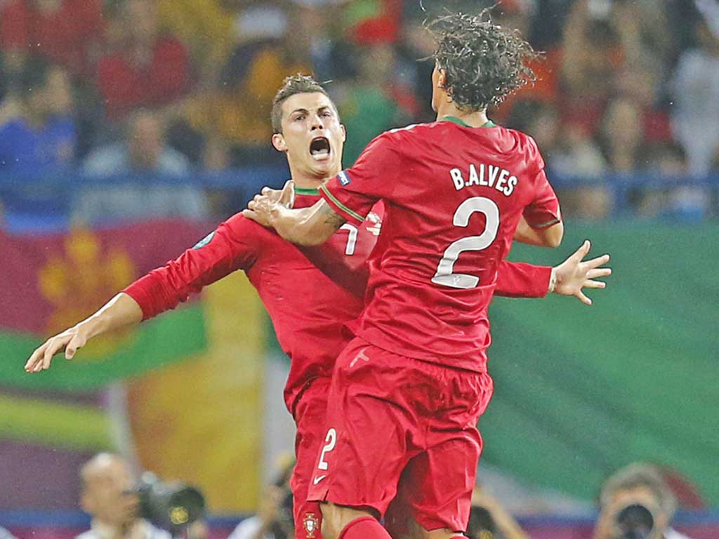 Cristiano Ronaldo (left) celebrates his second goal with Bruno Alves
