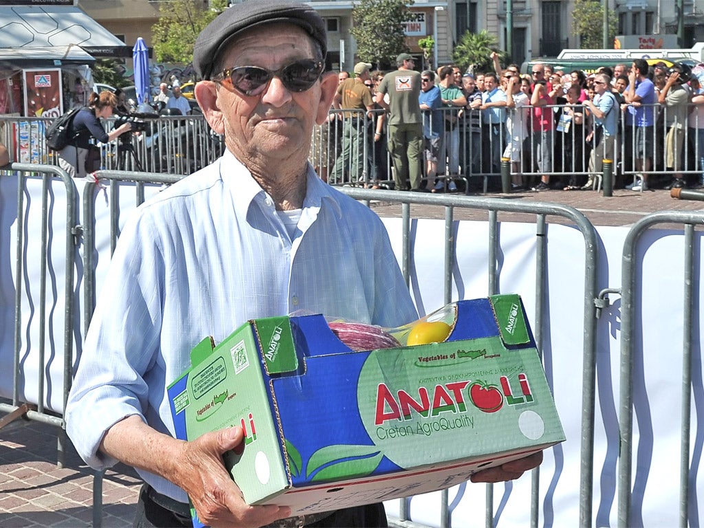 Thousands turned out to collect free fruit and vegetables in Athens yesterday