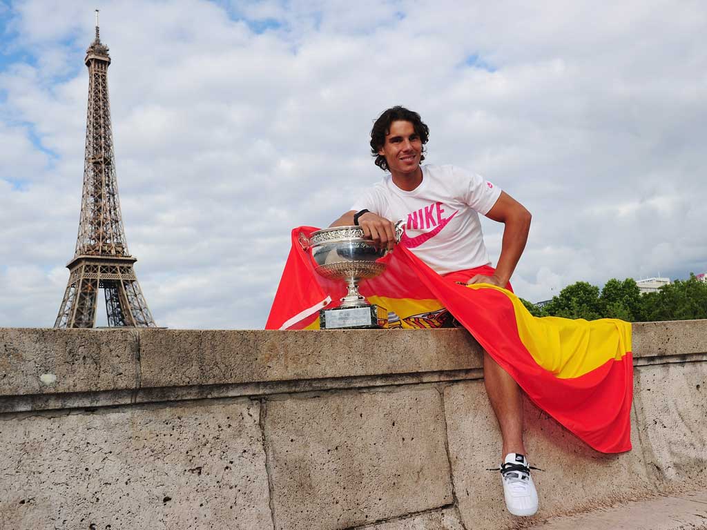 Grass is greener: Rafael Nadal with his French Open trophy in Paris
