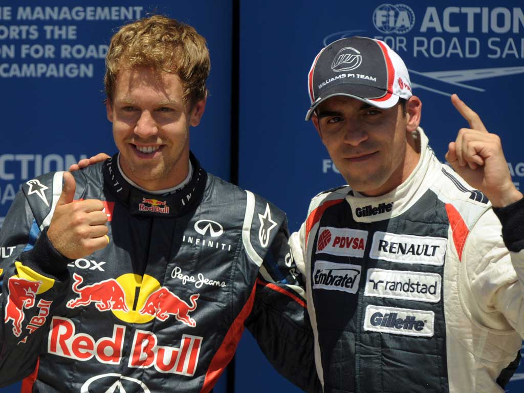 Thumbs up: Sebastian Vettel (left) celebrates with Pastor Maldonado