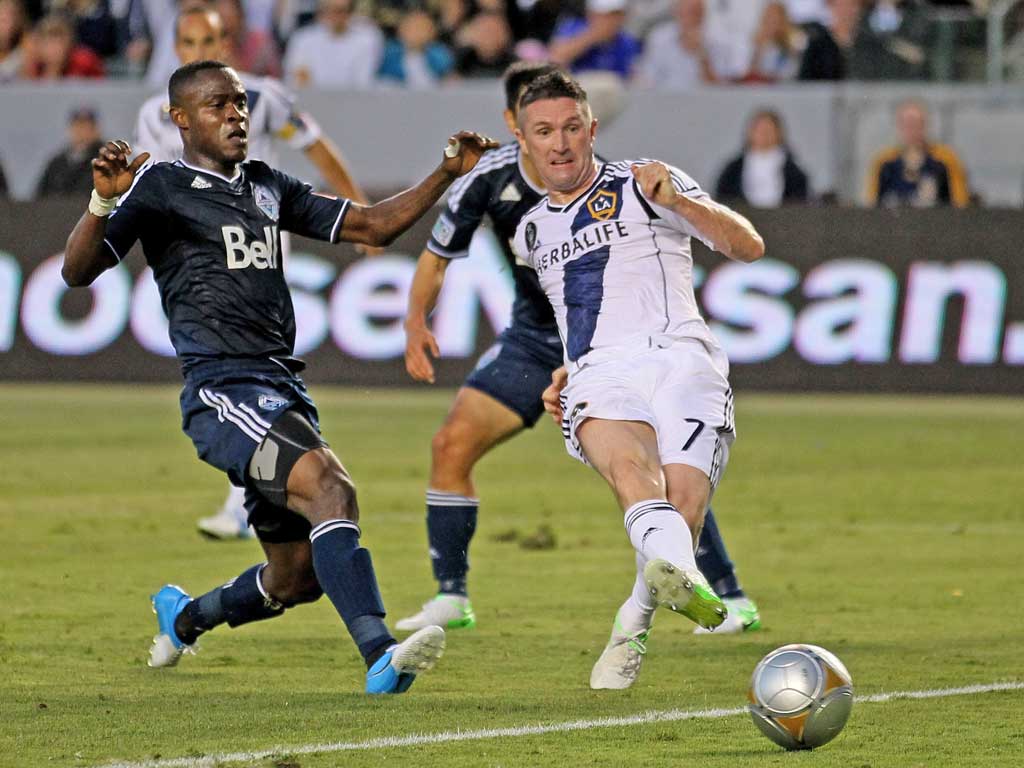 LA Galaxy striker Robbie Keane (right) scores against the Vancouver Whitecaps