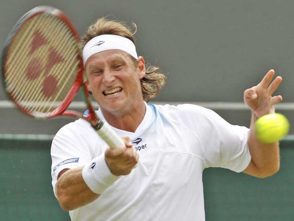 David Nalbandian plays a shot during his defeat by Janko Tipsarevic
