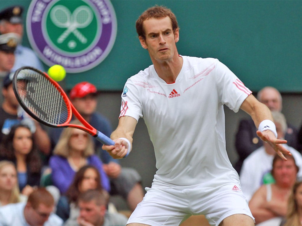 Andy Murray in action at Wimbledon on Tuesday - where he was supported by a large entourage