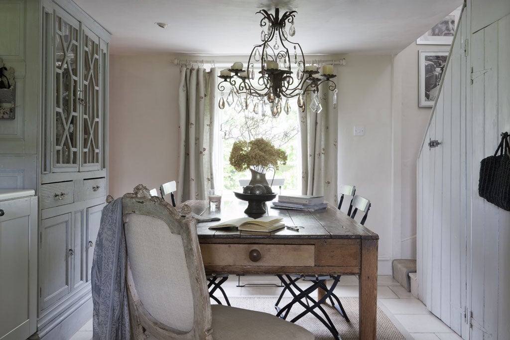 The kitchen table that acts as a focal point for the family, and the over-sized chandelier she transferred from a taller-ceilinged house
