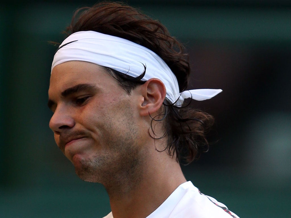 Rafael Nadal reacts during his second round defeat against Lukas Rosol