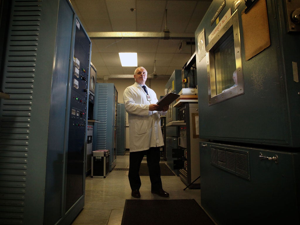 Helmet manufacturing expert Mark Applegate is pictured adjusting the settings in the Environmental Stress testing area for machinery i