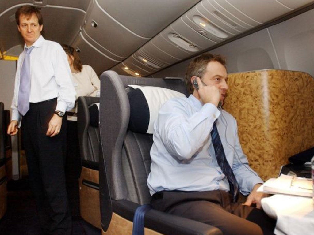 British Prime Minister Tony Blair, center, watched by his director of Communications and Strategy, Alastair Campbell, left