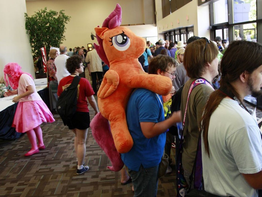 Matthew Zadonia carries a stuffed animal from the My Little Pony cartoons at BronyCon