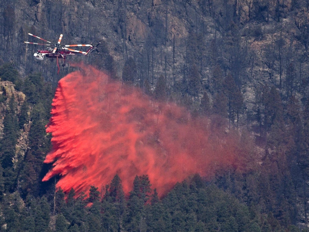 A helicopter drops fire retardant onto the Waldo Canyon Fire in
Colorado Springs yesterday