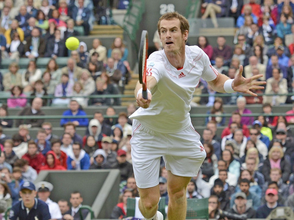 Andy Murray makes a return to Marin Cilic during their rain-interrupted match yesterday