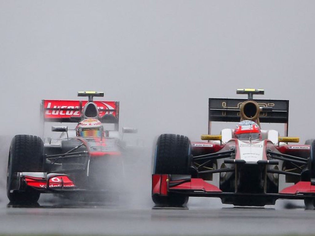 Lewis Hamilton comes up behind Narain Karthikeyan in practice