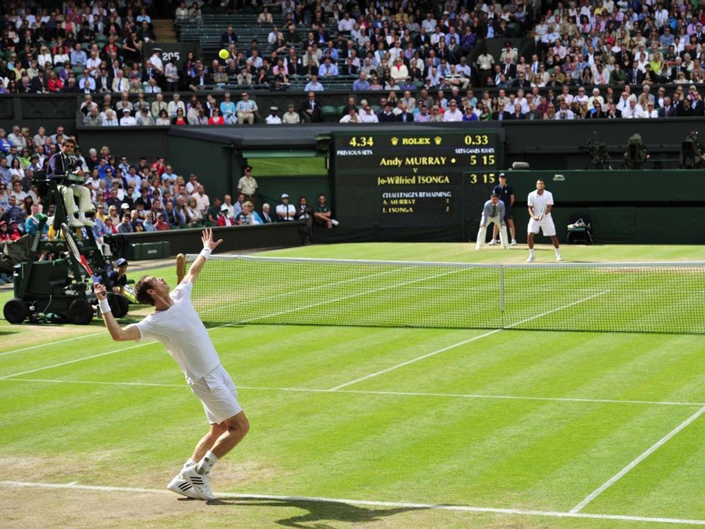 Andy Murray serves to Jo-Wilfried Tsonga yesterday