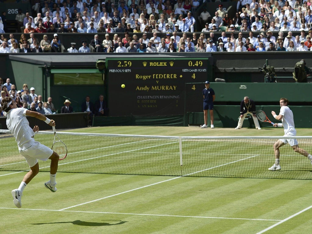 Roger Federer hits a return to Andy Murray yesterday