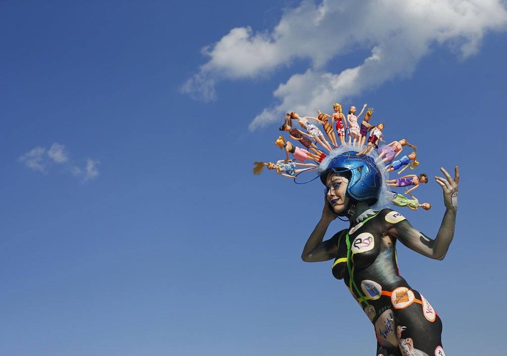 A participant poses with her body paintings in front of the Woerthersee lake during the 15th World Bodypainting Festival in Poertschach over the weekend.