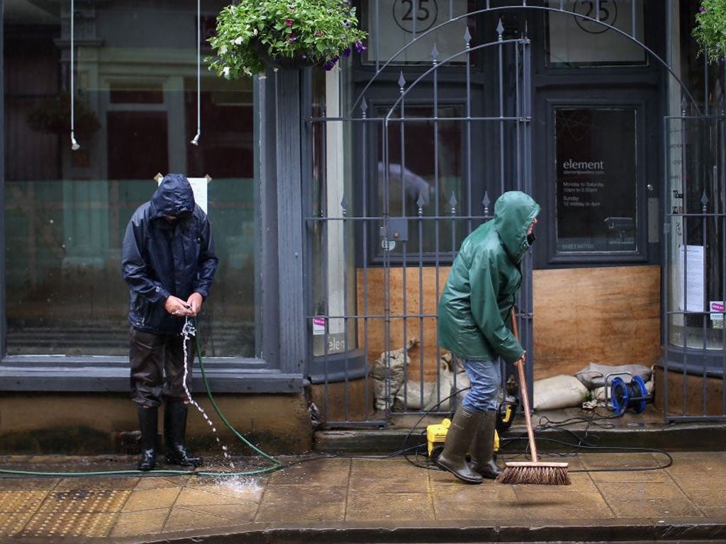 Residents and business owners clean up after flash foods Hebden Bridge yesterday